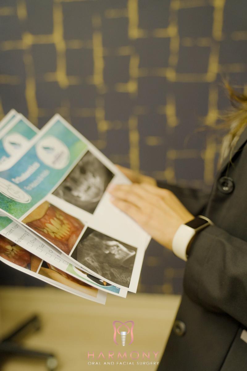 A person holding a booklet with images displayed on it.